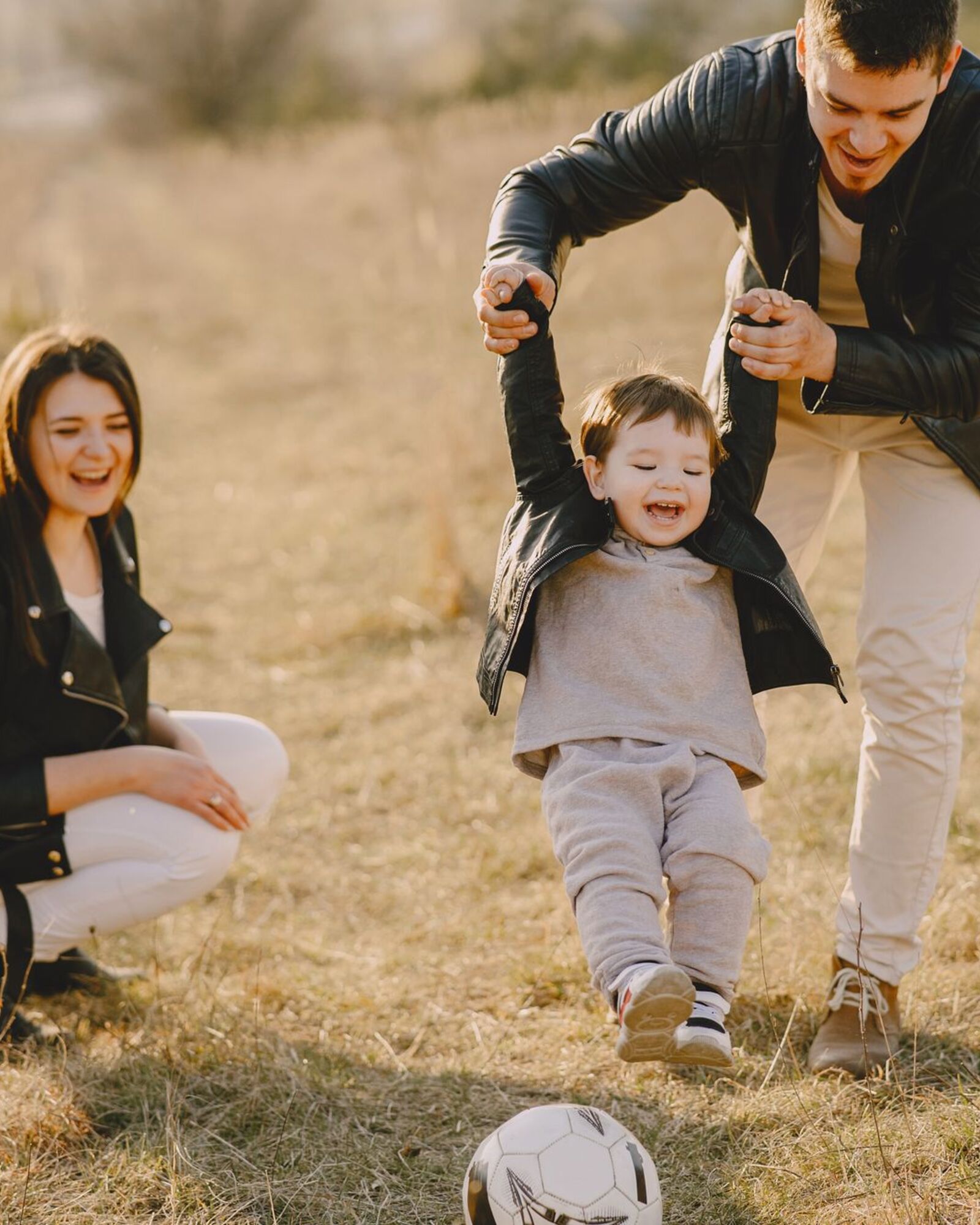 A smiling young family playing together outdoors — the kind of life Amato Insurance helps protect.
